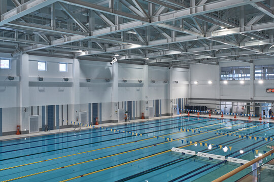 Olympic style indoor pool with lane dividers in spacious natatorium