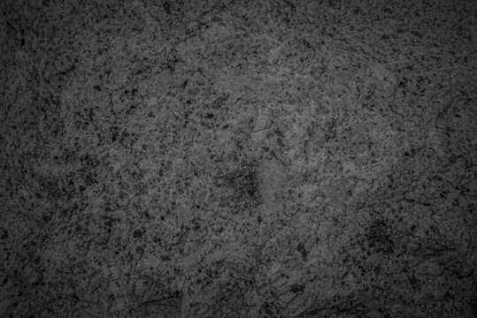Close up of grey granite surface texture background. Intrusive igneous rock