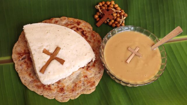 Pesaha Appam, Bread ,Paal religious Christian food on Maundy Thursday, Happy, Good Friday with rice flour Kerala India. Palm Sunday, Easter Sunday. Top view cross of coconut palm leaf background