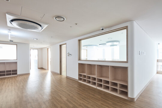 Warm family room with wood floor and built in cubbies in modern home