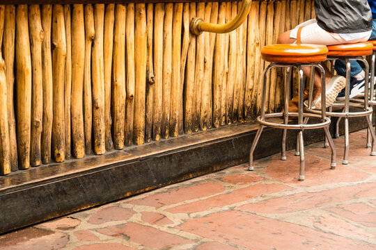 USA, New Mexico, Taos.  Stools pulled up to a wood faced bar. 