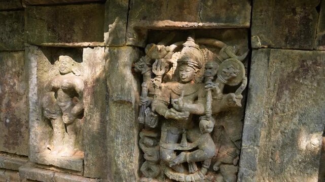 Close up of carved idols on ancient temple ruins in jungle. Detailed idols carved on old temple walls in jungle.