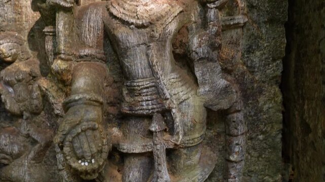 Close up of carved idols on ancient temple ruins in jungle. Detailed idols carved on old temple walls in jungle.