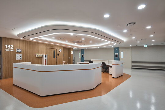 Warm hospital front desk with corridor and patient area beyond