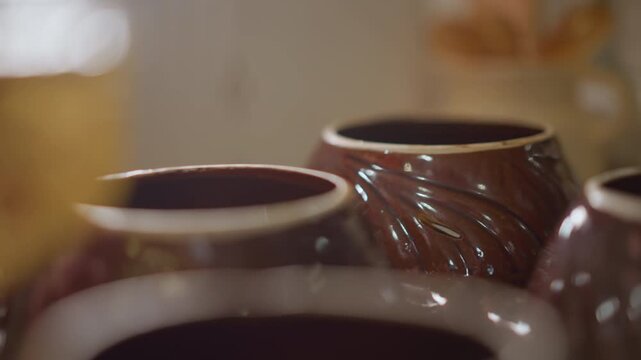 Closeup handmade ceramic bowls on countertop, soft natural light and warm tones, home cook arranging ramekins for recipe prep, shallow depth of field, glossy glaze texture and rustic kitchen