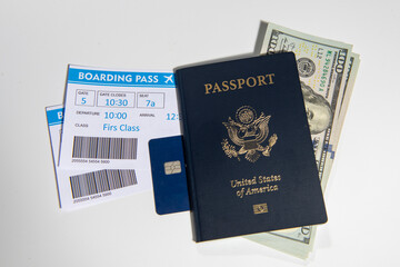 Fototapeta premium US passport with boarding pass. American passport with cash and credit. Travel and money for trip. USA passport and airline tickets with US dollars for travel. Passport boarding pass for travel.