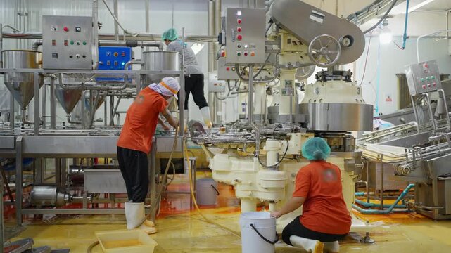 Machine Maintenance in Industry: A worker meticulously cleans machinery, demonstrating diligence and precision in industrial maintenance.
