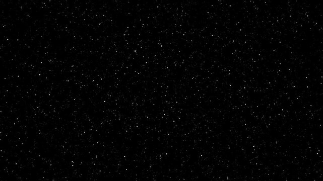 Glowing white particles falling slowly against a dark background in motion video footage