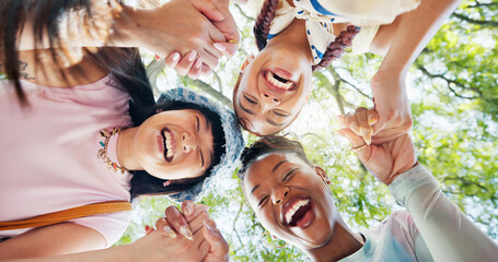 Fototapeta premium Women, portrait and holding hands with friends at park, bonding and laugh together for group reunion. Outdoor, low angle and people with smile for funny joke, friendship and humor in nature and break
