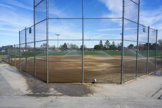 Baseball and softball field with sprinklers on