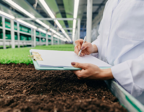 Scientist Recording Data in Indoor Vertical Farm