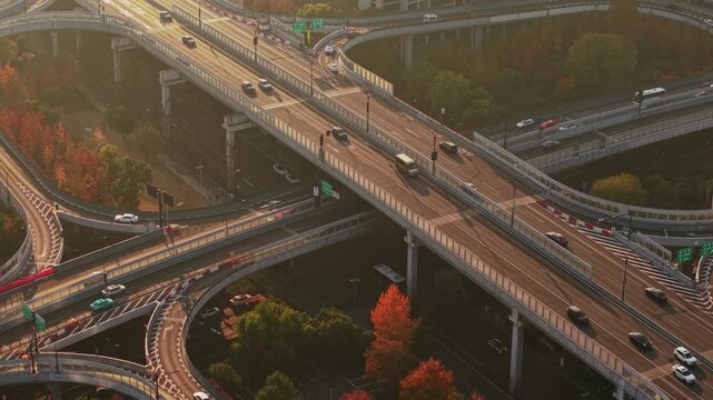 Aerial view of multilevel highway interchange with car and bus traffic in China during the sunset