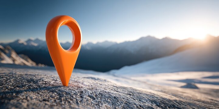 Bright orange map pin stands on snowy ground with mountain peaks beyond