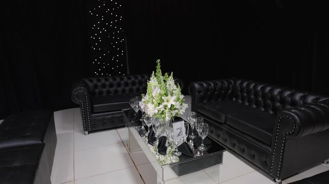 Rotation of Luxury Wedding Lounge Area With Black Chesterfield Sofas and Floral Centerpiece
