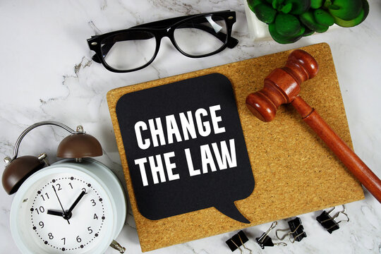Change the Law text on speech bubble with alarm clock and wooden gavel on marble background