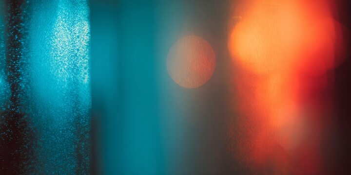 Soft light illuminates textured surfaces with vibrant blue and orange hues.