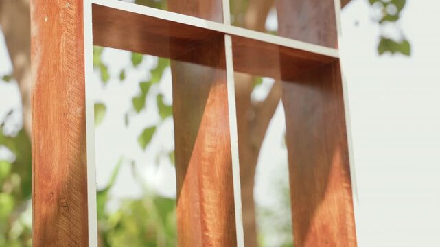 Sunshine illumination on wood structure. Radiant sunlight highlighting crafted wooden framework. Illuminated wooden lattice showcasing warm natural fibers with weathered and rustic finish