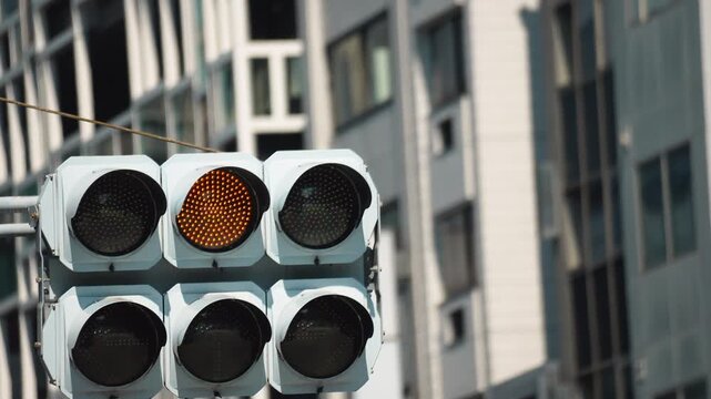 Footage of Traffic Signals Switching Colors in Sequence in the City.