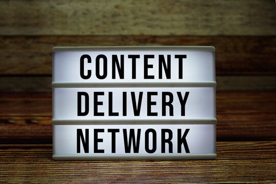 Lightbox with text "Content Delivery Network" on wooden background
