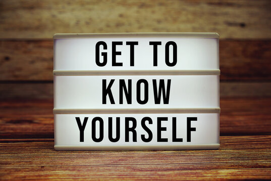 Lightbox with text "Get To Know Yourself" on wooden background