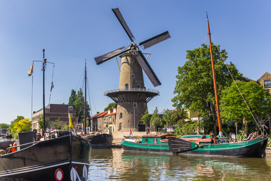 Historic windmill De Roode Leeuw in the harbor of Gouda, Netherlands