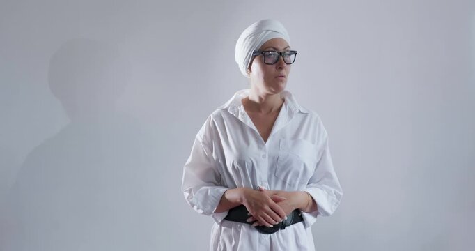 Business goal-oriented young woman in glasses and turban actively gesticulates and speaks