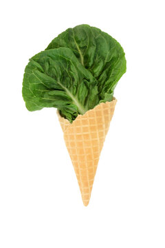 Surreal lettuce leaf ice cream cornet fun diet concept on white background. Healthy summer green organic nutritious vegetable food art design.