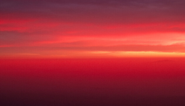Abstract deep red and orange gradient background with soft sunset clouds　夕焼けのようなソフトな雲が広がる濃い赤とオレンジの抽象的なグラデーション背景
