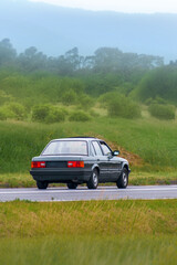 Fototapeta premium 90s era vehicle in pristine condition on rural road
