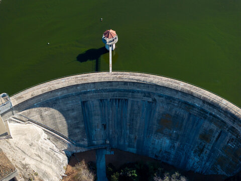Aerial view large concrete dam spillway water infrastructure