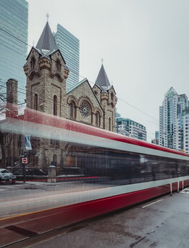 Blurred streetcar travelling down road in Toronto, Ontario, Canada.