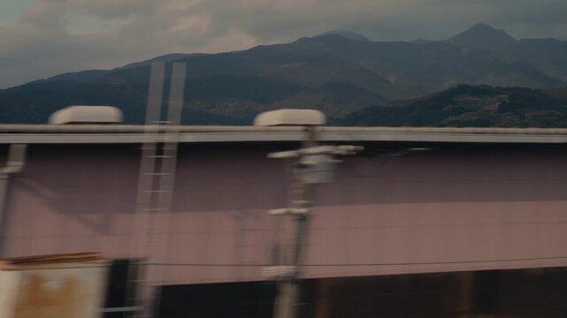 Landscape rushing past from shinkansen window with strong motion effect