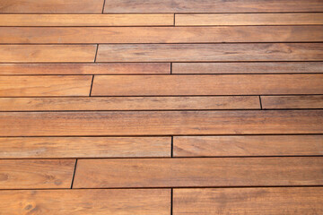 Obraz premium Wooden walkway surface with natural grain and warm brown tones.