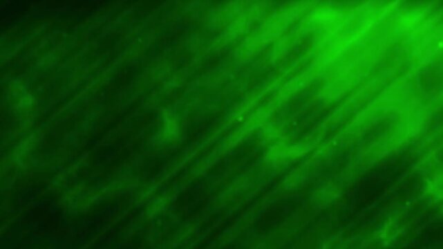 Abstract green background of water depth with falling particles and green light ray