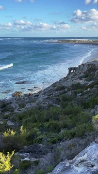 4k 60p vertical footage of dramatic coastal view to Struis Point (Struispunt) and Saxon Reef from the cliffs near Waenhuiskrans Cave, Arniston. Turquoise Overberg waters, Western Cape, South Africa.