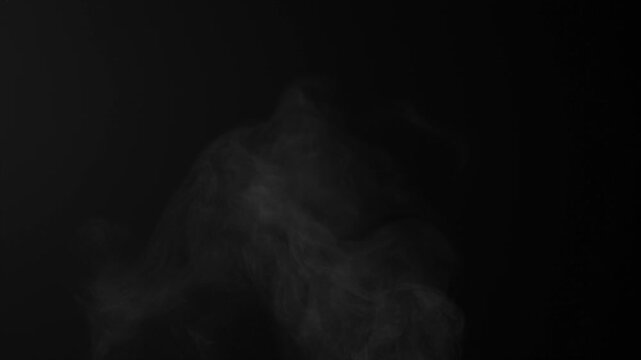 Steam, smoke, vapor isolated on black background. Smoke steam spray, abstract vaporing water, texture of cold mist, hot vapor, fog effect closeup, black screen. Hot food, drink. Slow motion  