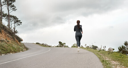 Naklejka premium Fitness, back and person on road with running, cardio or stamina training in physical activity. Space, practice or athlete on path with jog, outdoor workout and sports endurance in New Zealand.
