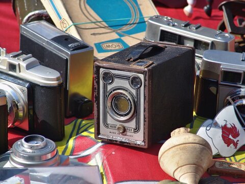 Vintage box camera and antique items on market stall