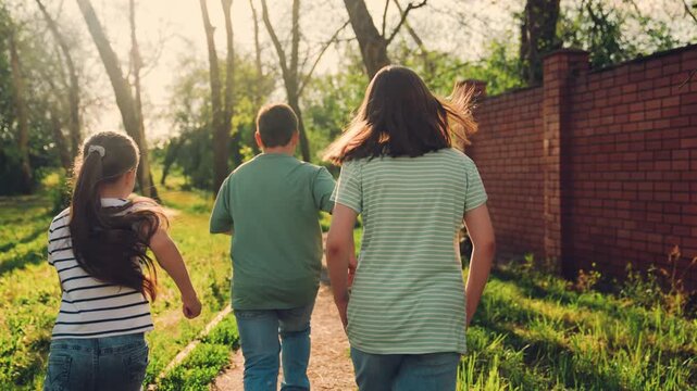 people cheer, happy child runs fast, friends run, little athletes in park, fast leg power, classmates running together happily., bright summer sun., girl follows, bright sun, school team practice