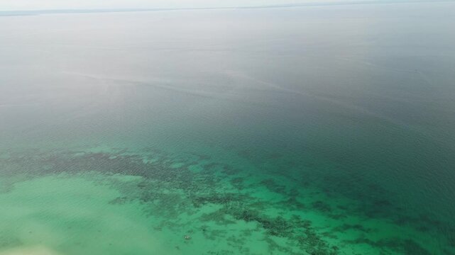 Aerial view of a beach resort on Bantayan Island, Cebu, Philippines. Pristine white sand, turquoise ocean, and lush tropical greenery in a paradise travel destination