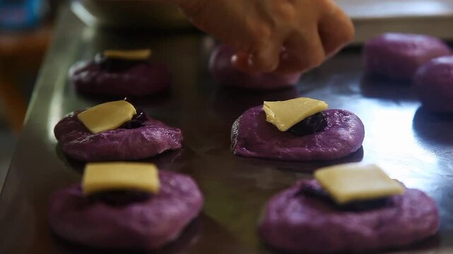 Filipino bread called Ube cheese pandesal being prepared for baking.