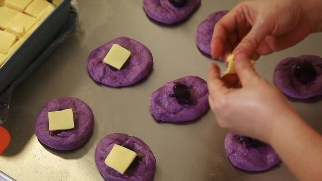 Filipino bread called Ube cheese pandesal being prepared for baking.
