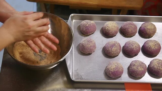 Filipino bread called Ube cheese pandesal being prepared for baking.