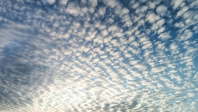 Blue sky with white puffy clouds, beautiful sky background texture. Clean air and clouds