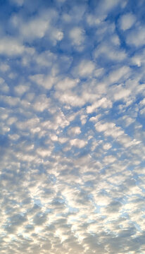 Blue sky with white puffy clouds, beautiful sky background texture. Clean air and clouds