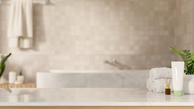 White towel with diffuser and cleanser tube on marble counter table across tub in tile wall bathroom