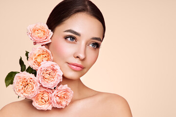 Portrait beautiful young woman with clean fresh skin. Model with healthy skin, close up portrait. Cosmetology, beauty and spa. Girl with a rose flower