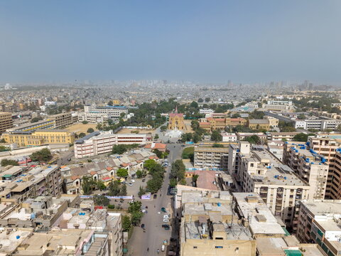 Aerial view of St. Patrick's Cathedral surrounded by dense urban buildings and the hazy city skyline in Karachi, Sindh, Pakistan.