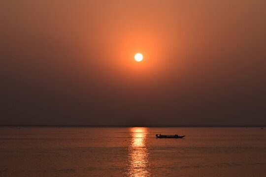 Golden Sunset in Padma River - A Moment of Pure Tranquility. As the sun sets over the Padma River, golden light spreads across the flowing water, creating a breathtaking scene of calm and beauty. 