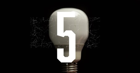 Glowing frosted bulb showing spiderweb cracks in studio dark, revealing screw base and white 5 © vectorfusionart